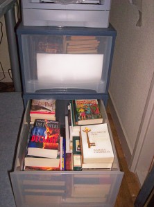 These two huge plastic drawers are also full of books waiting to be read. But the real book-trove, because of the "slings and arrows of outrageous fortune," is now back in Illinois: I have an entire room there stuffed with books. Oh, to have them all beneath one roof someday!