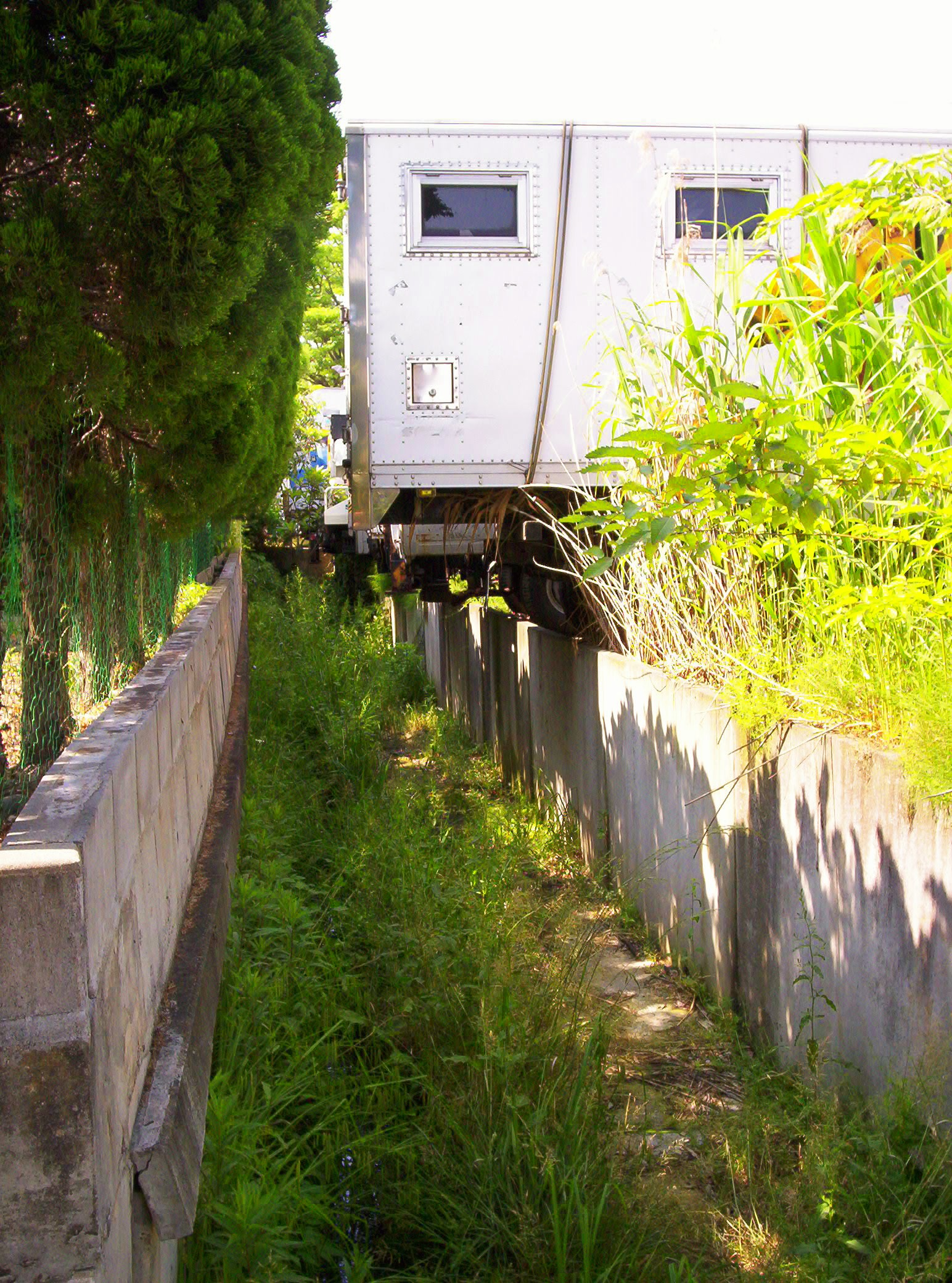 Finally, this is along the Lavender Path. This is a truck bed, parked so that it's sticking over a weed-grown drainage ditch. The truck seems not to have been moved in a very long time. Wouldn't you love to set up a writing house in that truck bed?! Well, I would, anyway. . . .