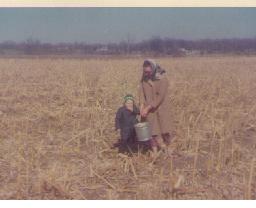 1968: Mom and me in the field. What, am I EATING the corn we're gleaning?!